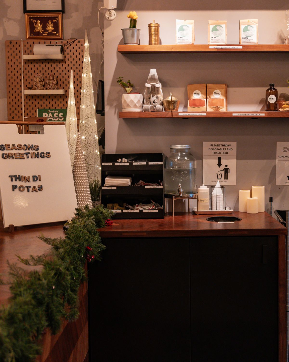 The counter at Thindi Cafe under hanging plants