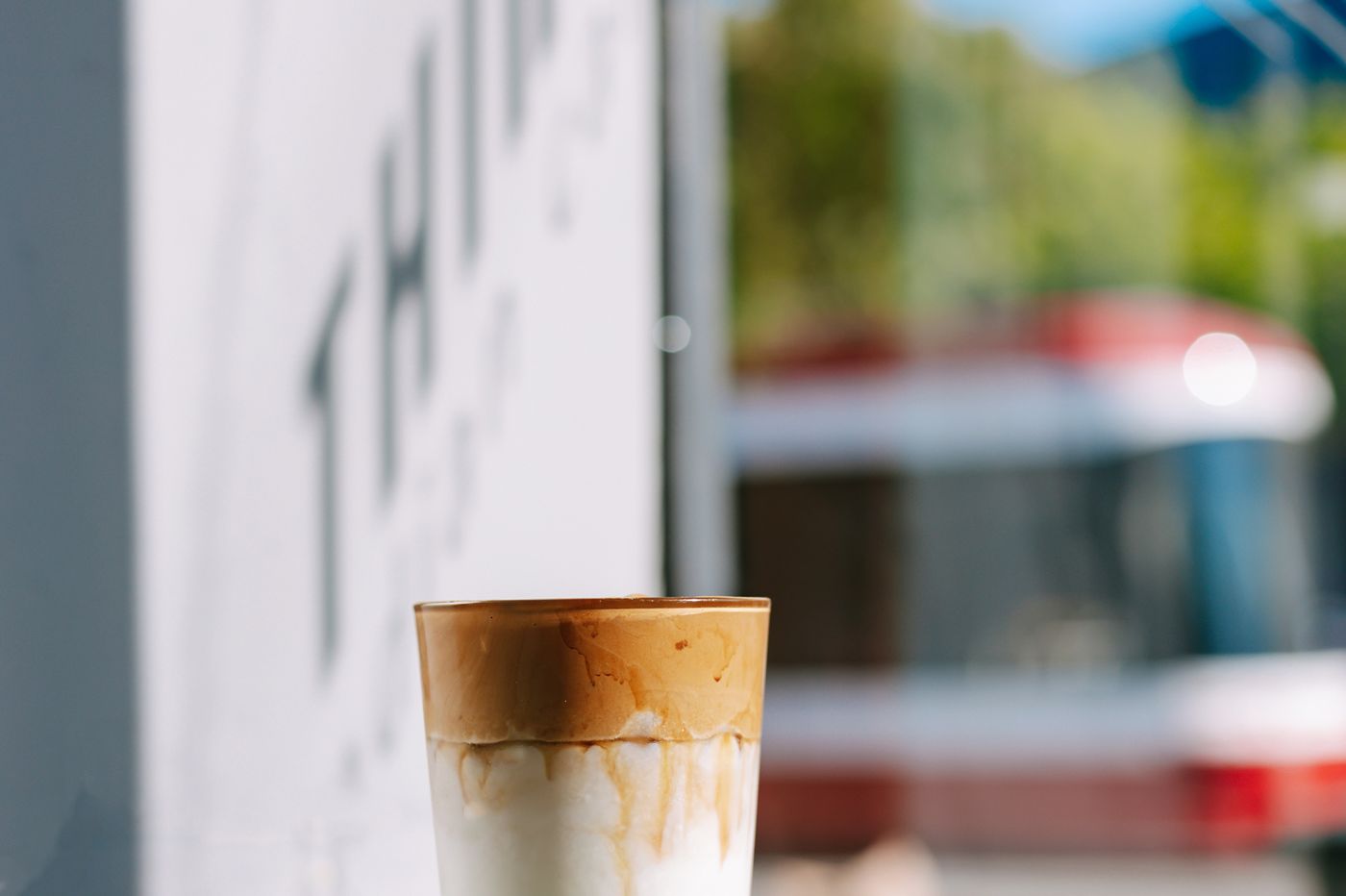 The Thindi sign on the College Street storefront with a coffee in the window